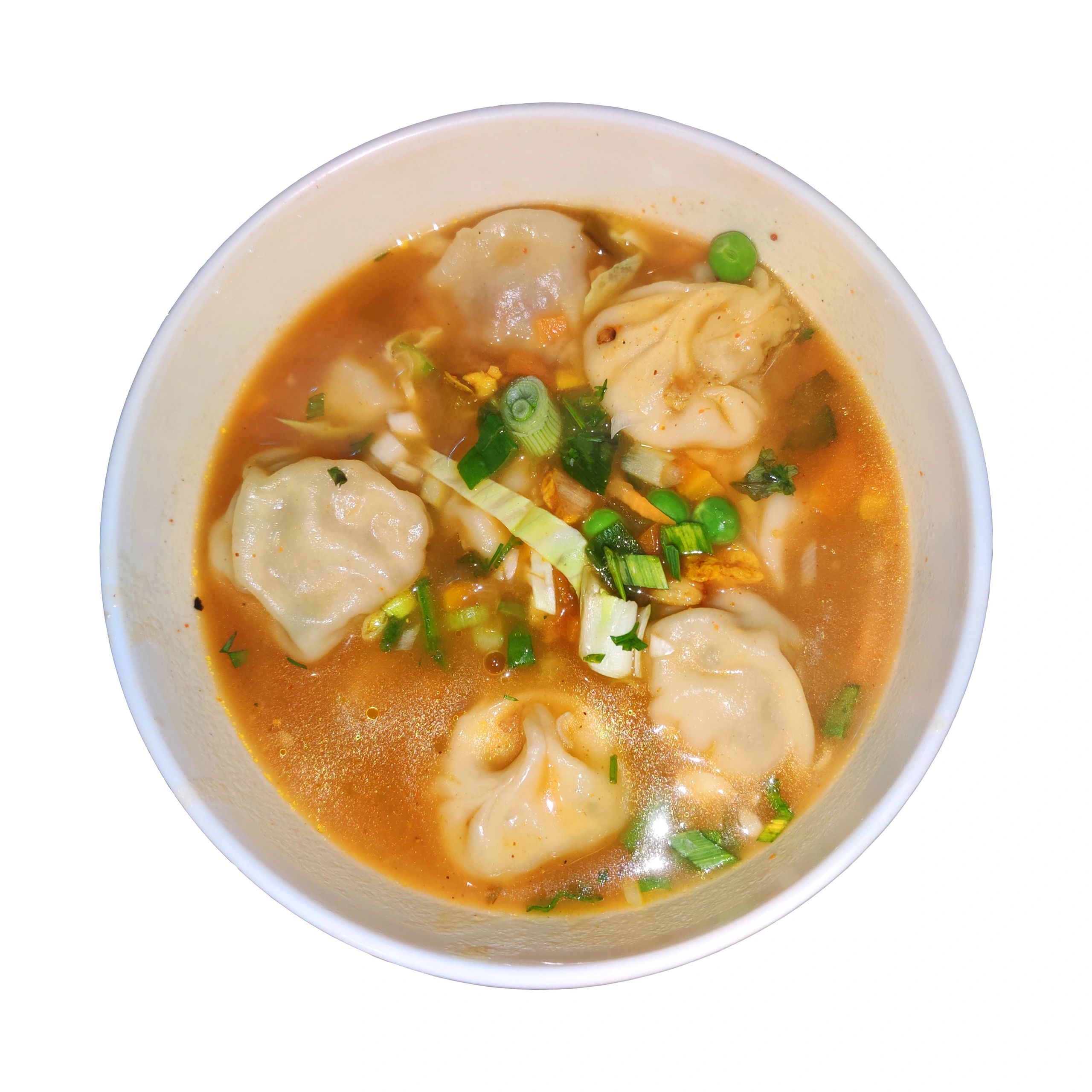 Steamed momo dumplings served with jhol achar (spiced dipping sauce), close-up