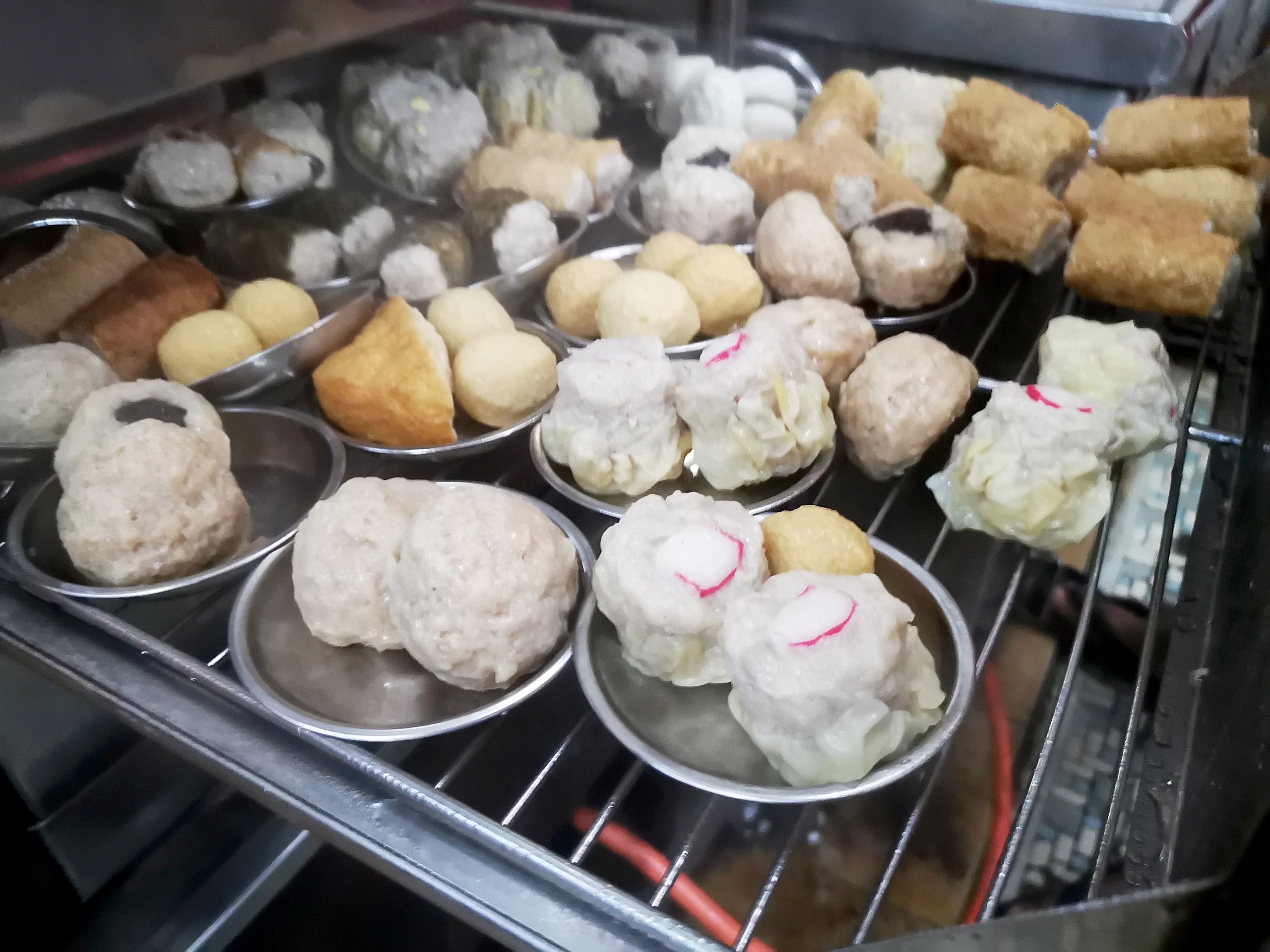 Steamed dumplings in a bamboo steamer tray, close-up